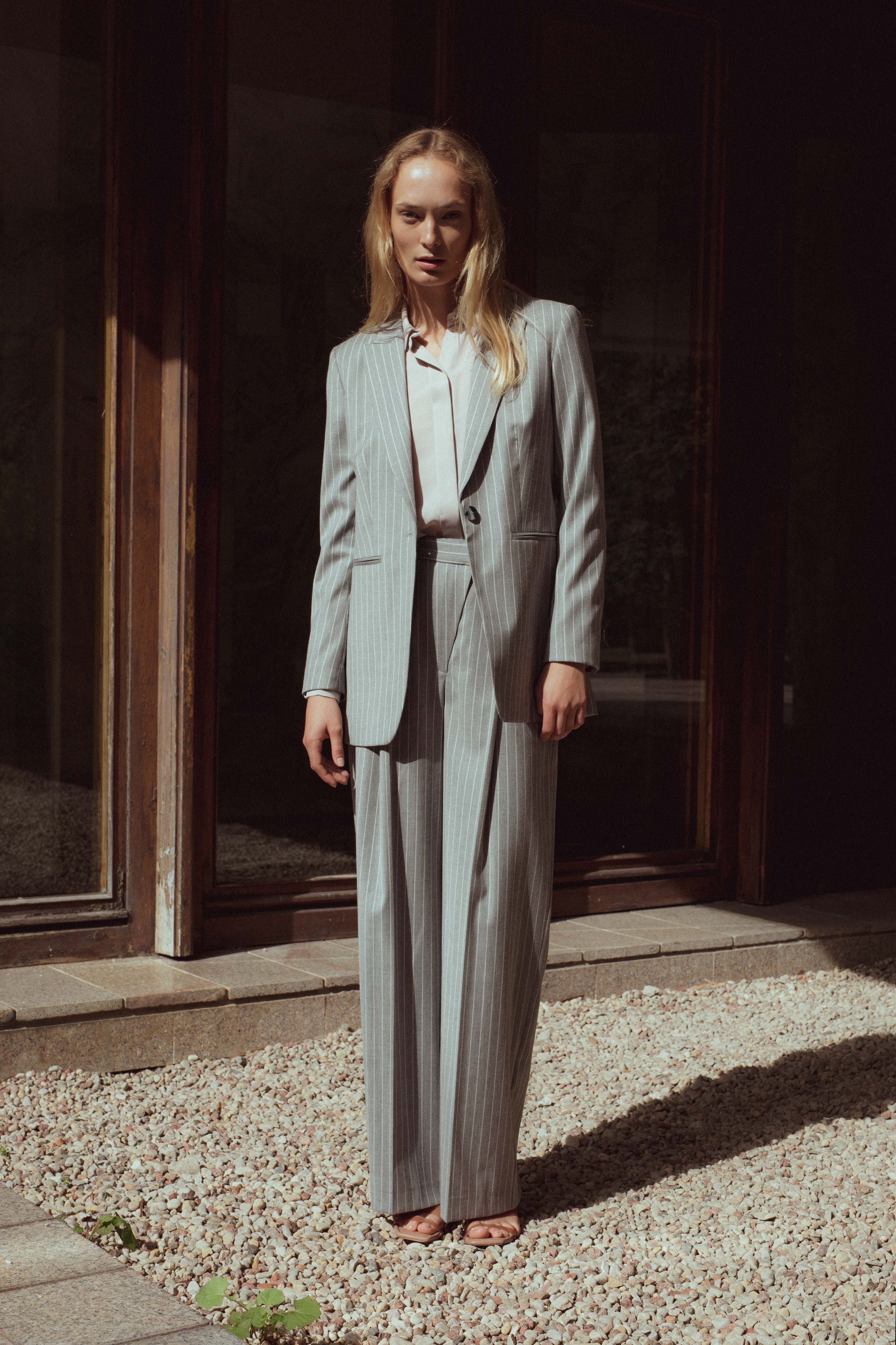 STRIPED WIDE-LEG TROUSERS WITH ASYMMETRIC CLASP