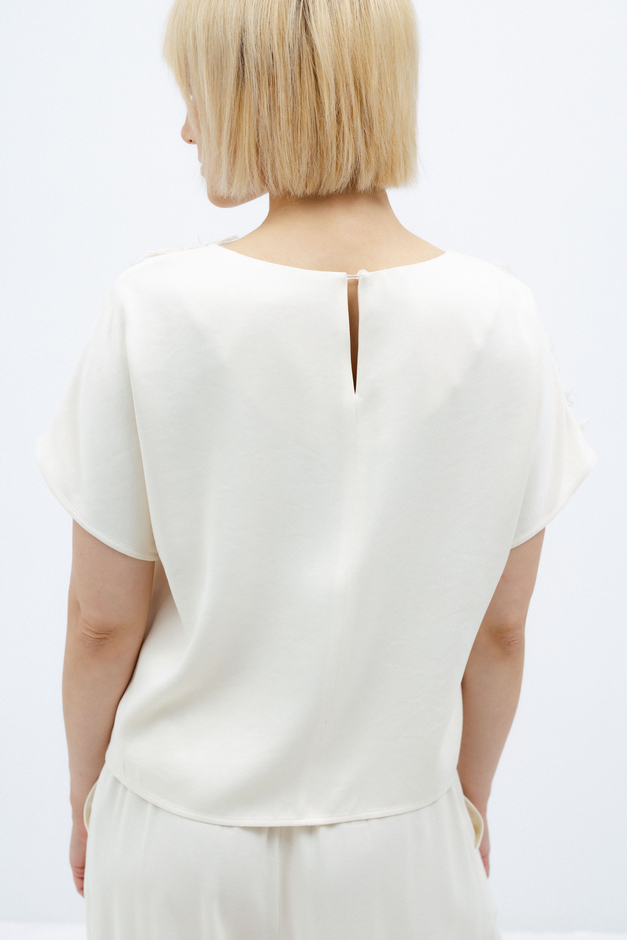 MILK-SHADE BLOUSE WITH ASYMMETRICAL APPLIQUE